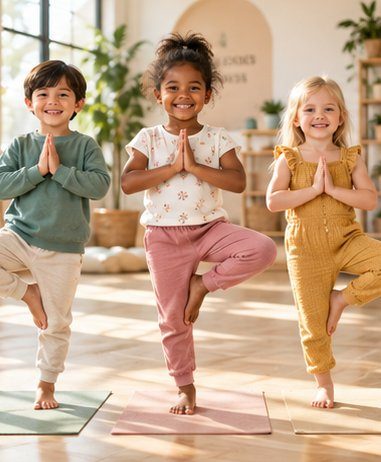 Three smiling kids balancing in tree pose